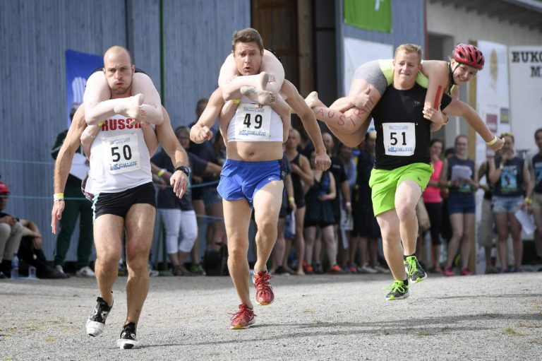 Couple Defends World Wife-Carrying Championship Title